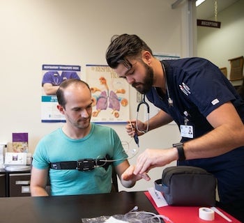 Respiratory therapy student with patient