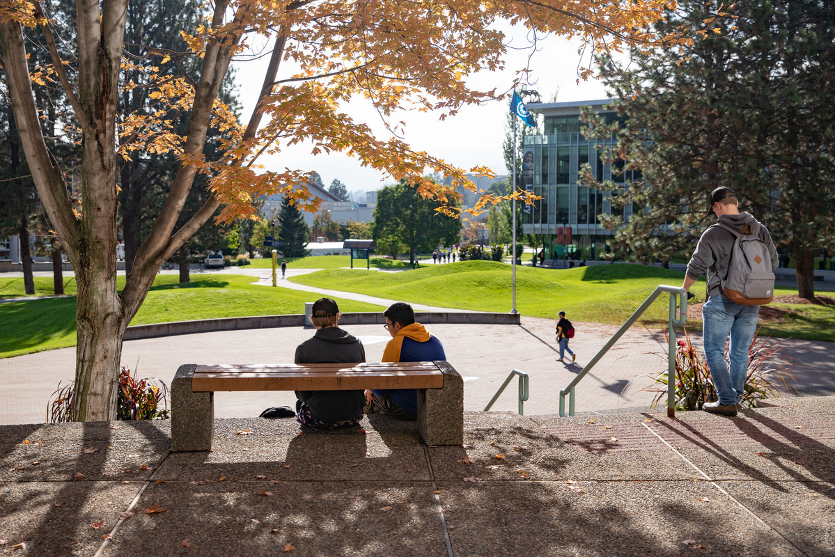 TRU students sitting in front of the Campus Activity Centre