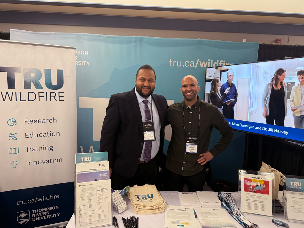 Ravi Parmar, BC's Minister of Forests stopping by the TRU Wildfire booth and shaking hands with Dinyar Minocher, director, TRU Wildfire at the BC Natural Resources forum, Prince George, Jan 2025